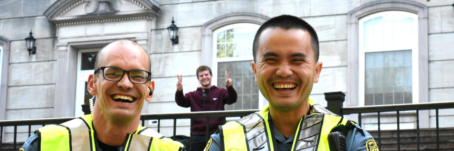two smiling UMPD officers